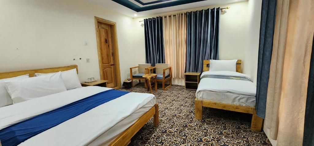 Family room with multiple beds at Cloud Rest Skardu